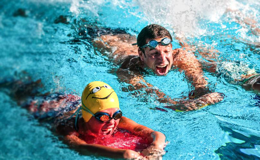 Coach and Age Group Swimmer in the Water